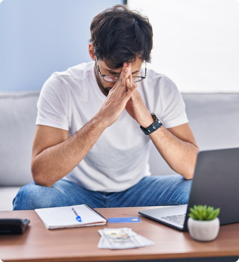 man-sitting-on-couch-deep-in-thought